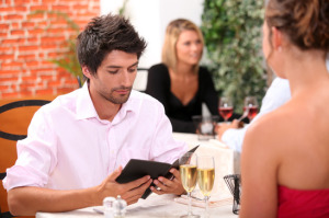 Young man looking at a menu in a restaurant